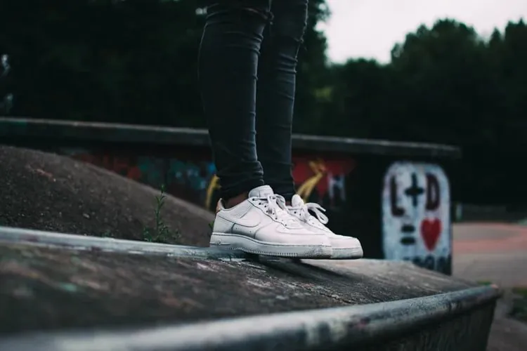 White trainers worn on a concrete ramp