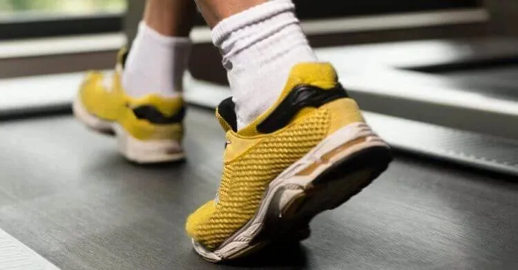 Running shoes mid-stride on a treadmill